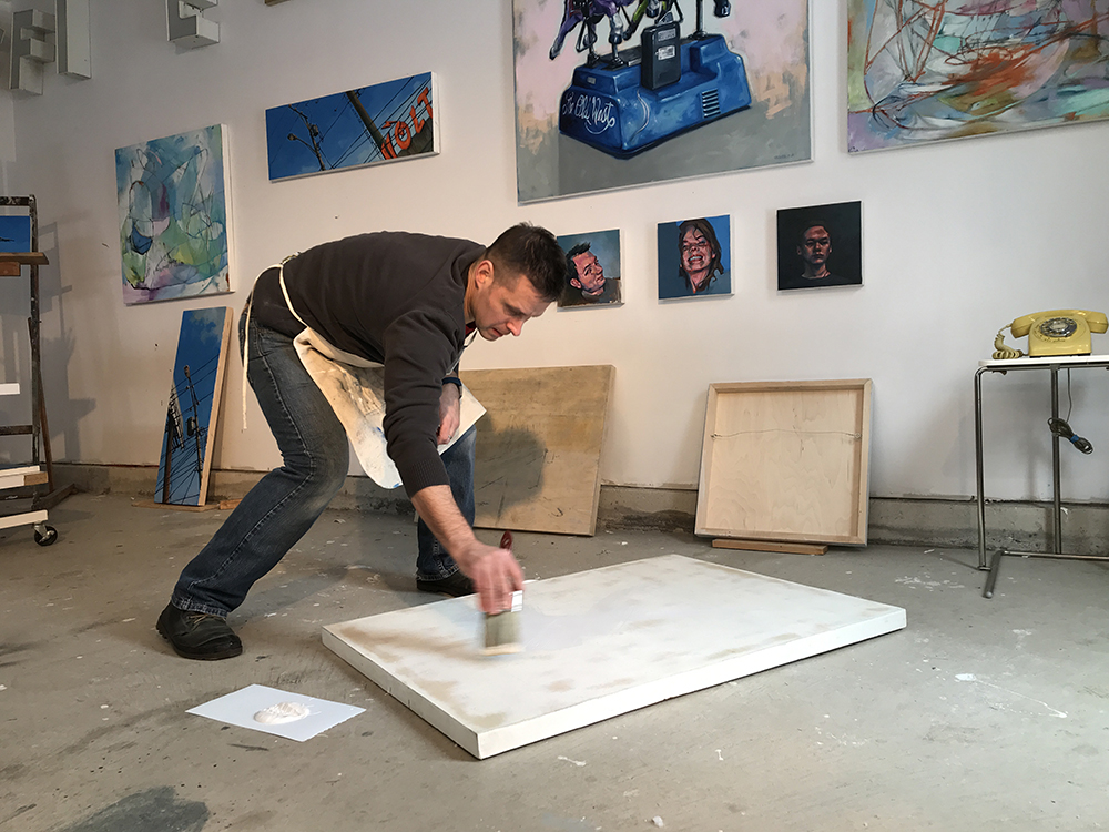 Artist in the studio preparing painting